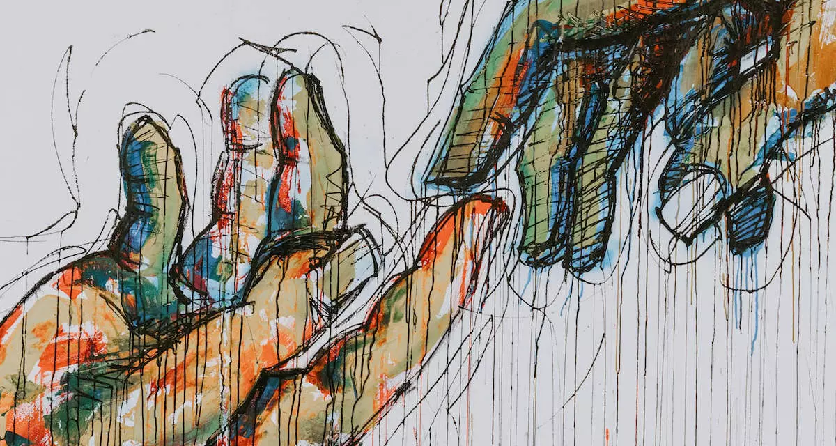 Wandmalerei zweier sich reichender Hände. Foto: unsplash/Claudio Schwarz.